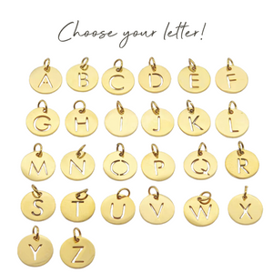 a set of gold charms with the letters of the alphabet