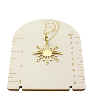 a white clock with a gold snowflake on it